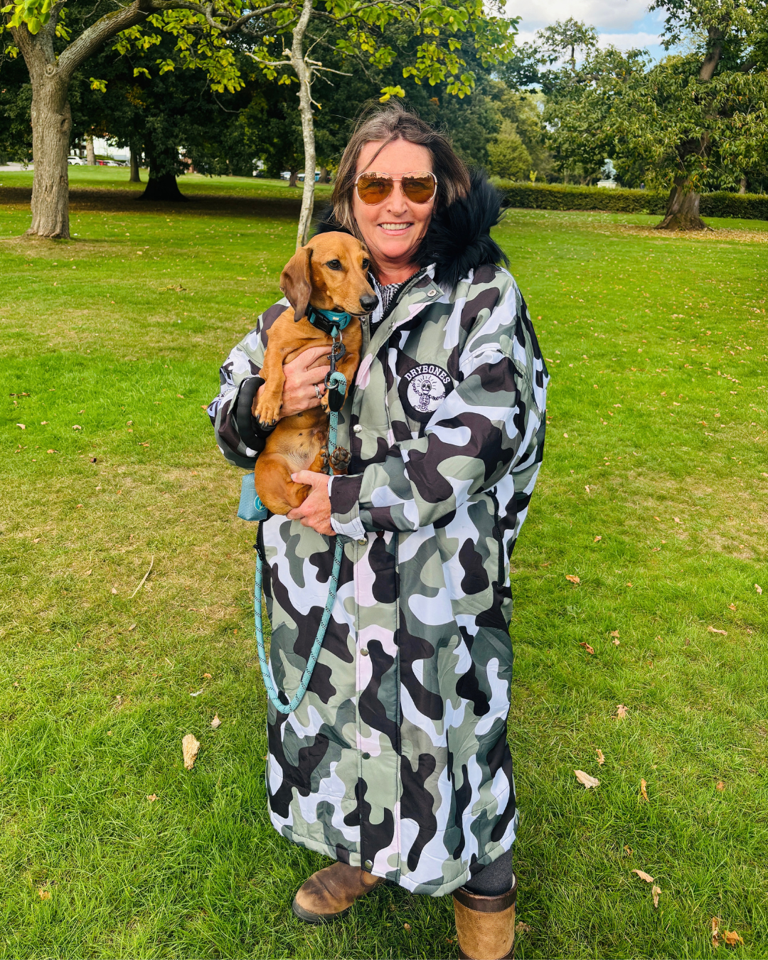 Urban Arctic camo waterproof changing robe with black faux fur hood and hues of olive green, black, white and grey