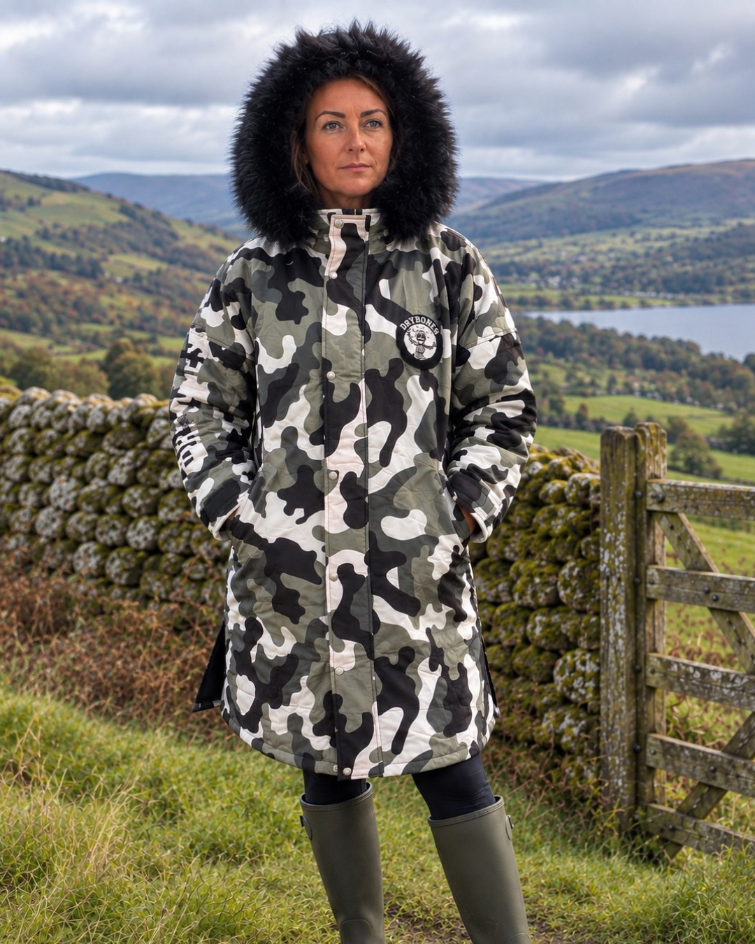 Urban Arctic camo waterproof changing robe with black faux fur hood and hues of olive green, black, white and grey. AI Generated image.